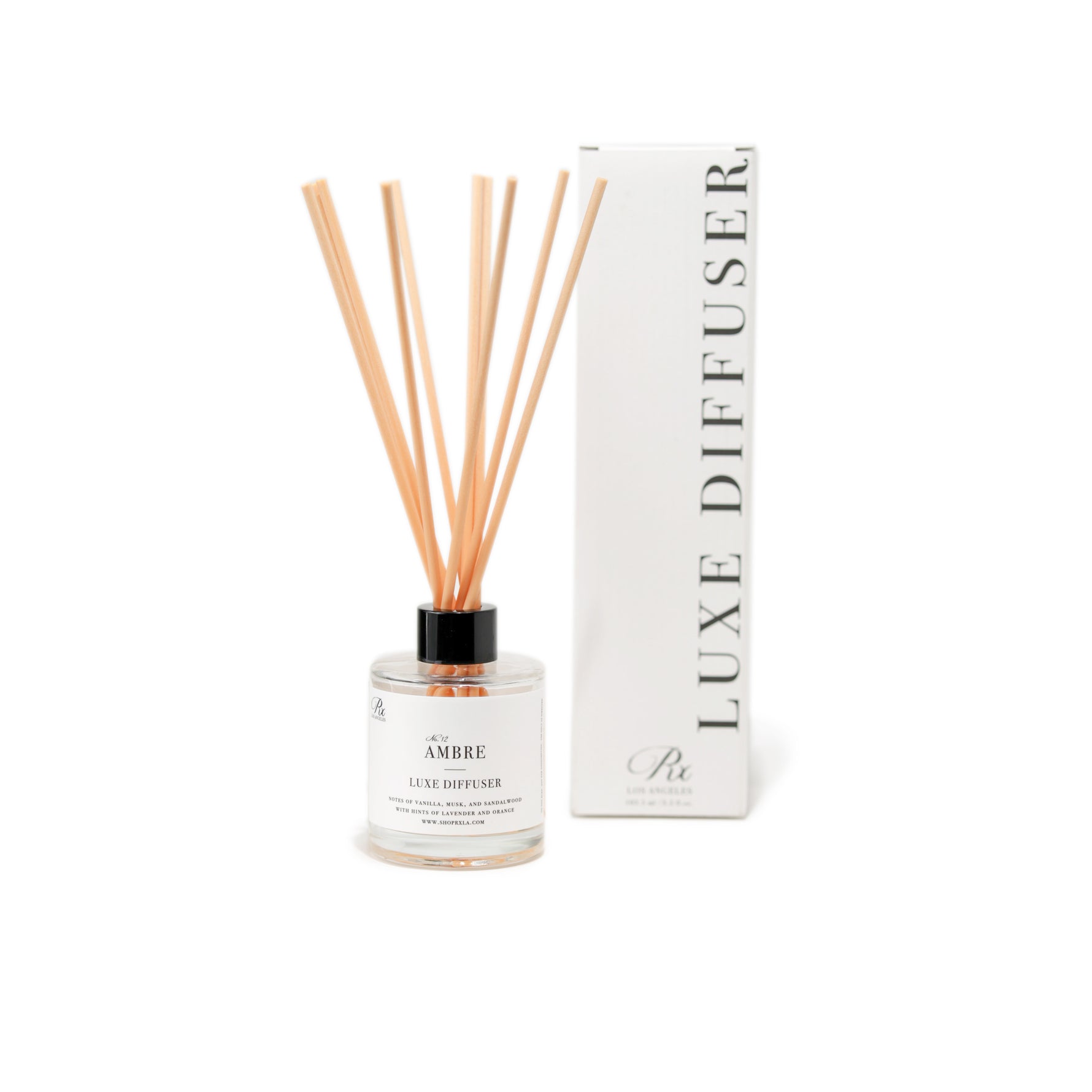 Ambre reed diffuser with a luxurious blend of vanilla, musk, and sandalwood, infused with essential oils of orange, lavandin, balsam, and lemon. Creates a warm, inviting, and sophisticated ambiance.