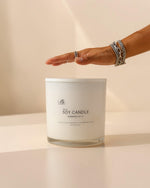 extra large candle with hand to show size