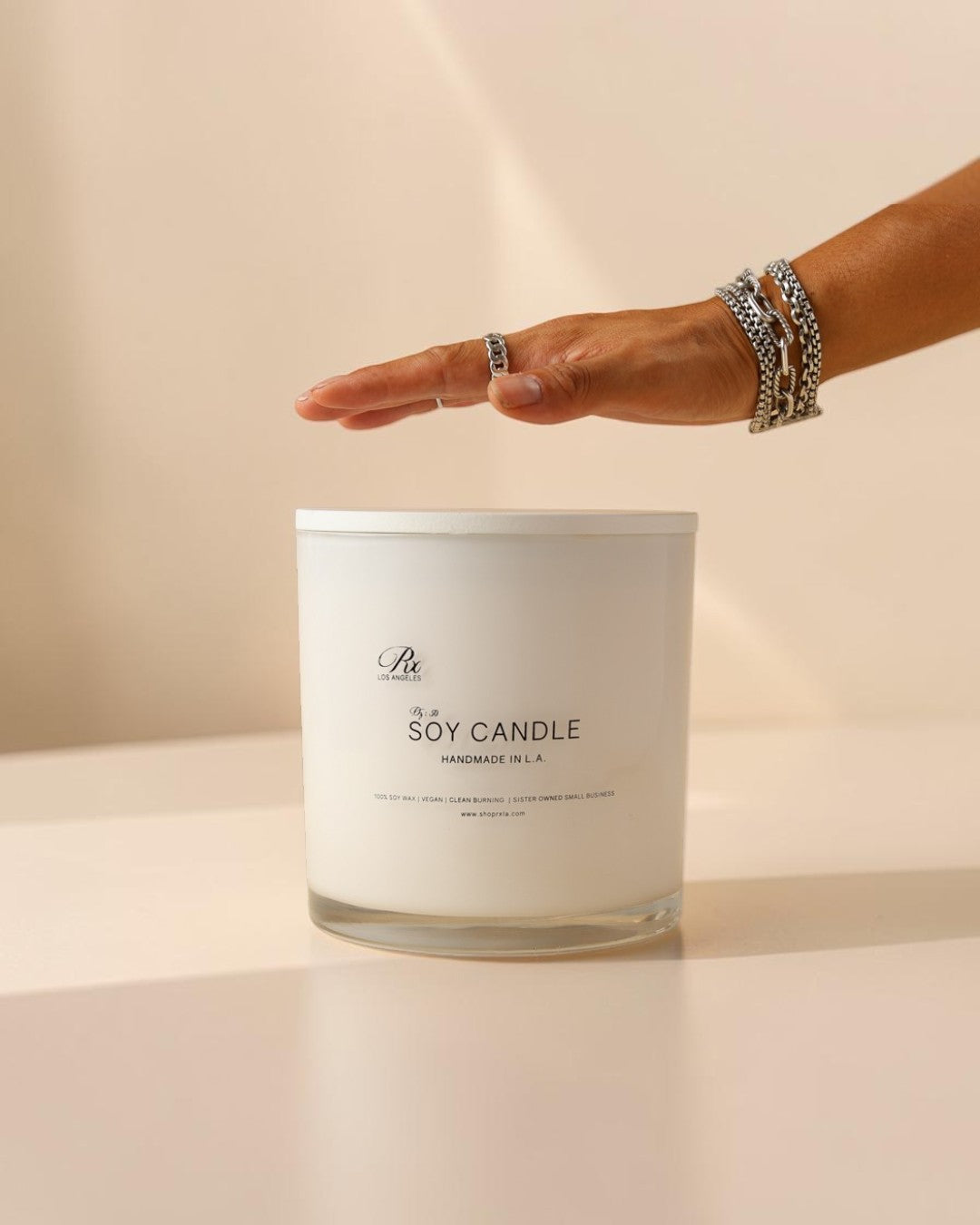 extra large candle with hand to show size