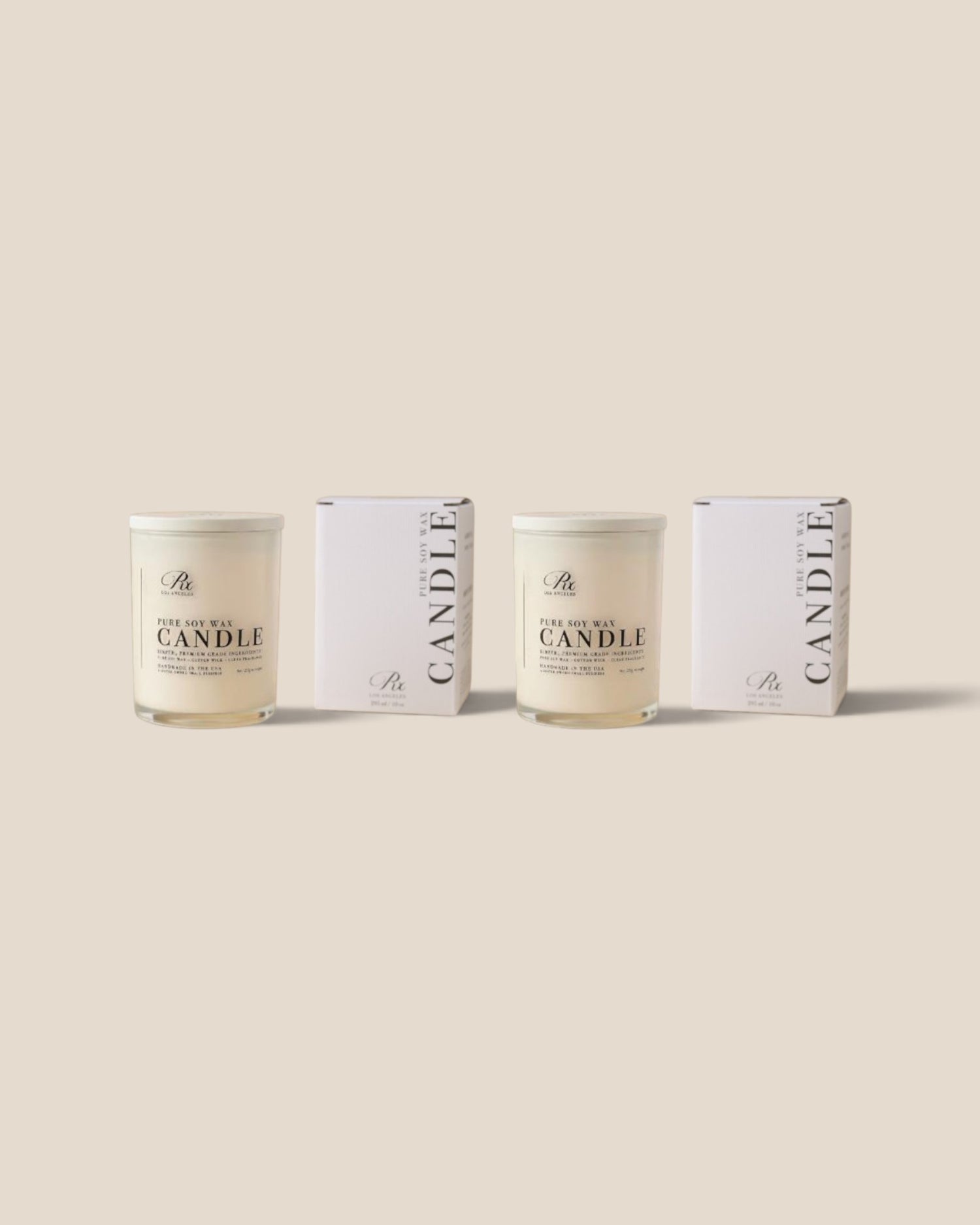 Two glass jar candles with cream-colored wax and white lids, displayed alongside their matching white packaging boxes on a solid beige background.