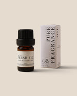 A bottle of Rx Pure Fragrance Oil with 'Fresh Fig' scent next to its white packaging box, set against a solid beige background.