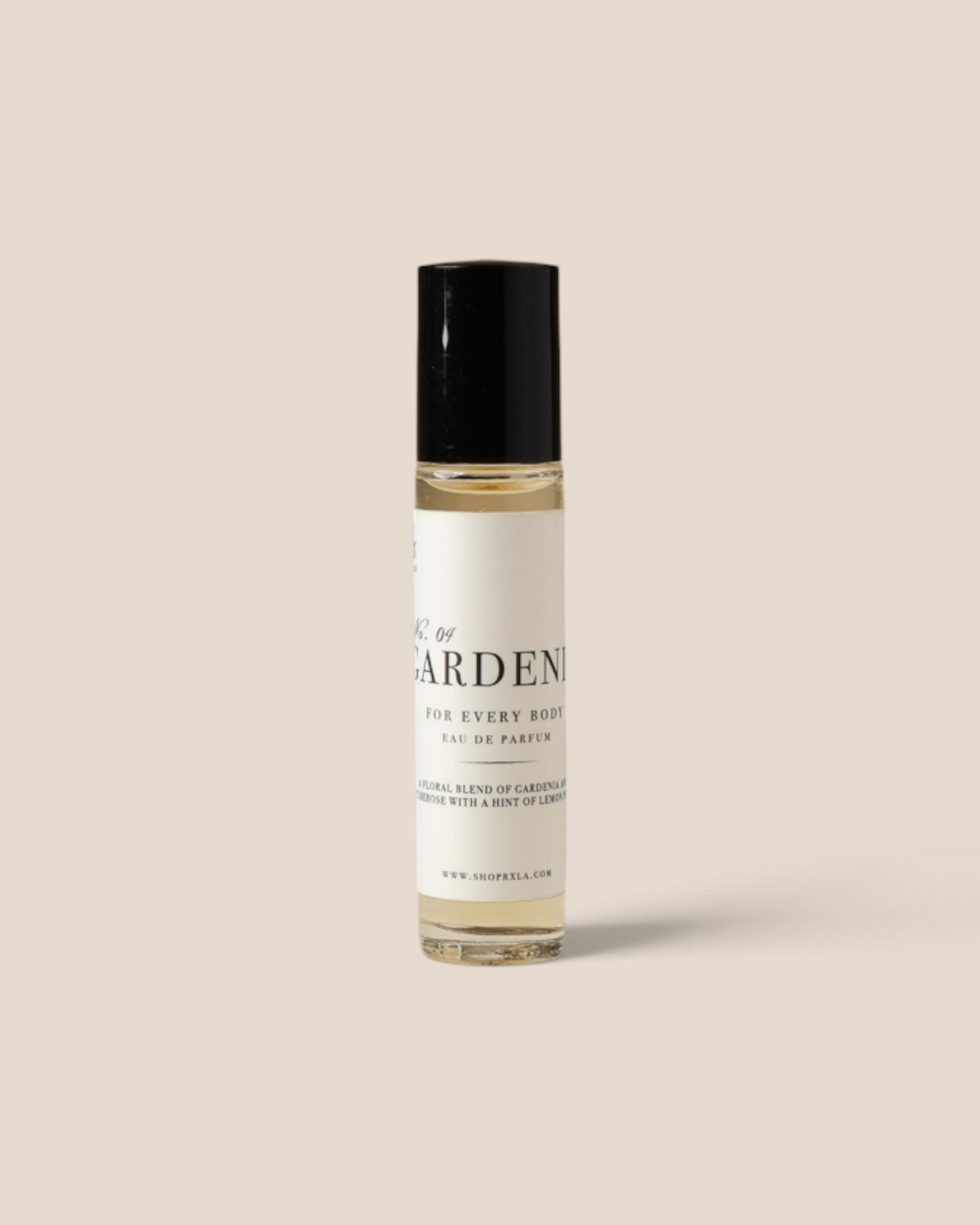 A clear cylindrical bottle with a black cap and a cream-colored label, centered on a solid beige background.