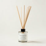 A reed diffuser bottle with natural wood reeds, a black cap, and a white label reading 'A La LAVENDER OAK LUXE DIFFUSER' on a clean off-white background.