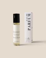 A clear glass roll-on bottle with a black cap stands next to its white rectangular box. The bottle label reads 'Mango STICKY' and 'FOR EVERY BODY', while the box displays 'EAU DE PARFUM' vertically with a small 'Ru' logo below.