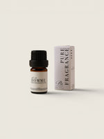 A small amber glass bottle of fragrance oil with a black cap stands next to its tall white box packaging, both labeled 'Pure Fragrance' and 'Citrus', on a clean off-white background.