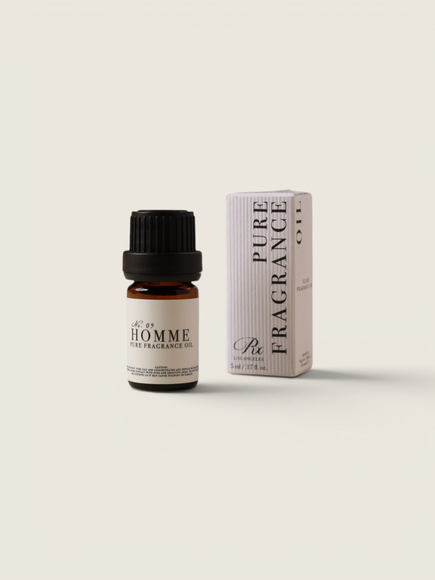 A small amber glass bottle of fragrance oil with a black cap stands next to its tall white box packaging, both labeled 'Pure Fragrance' and 'Citrus', on a clean off-white background.