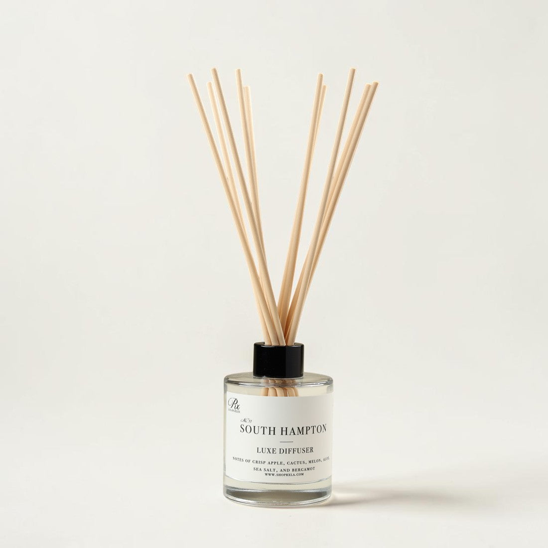 A South Hampton reed diffuser bottle with a clear glass container, white label, black cap, and natural wood reeds, photographed on a clean off-white background.