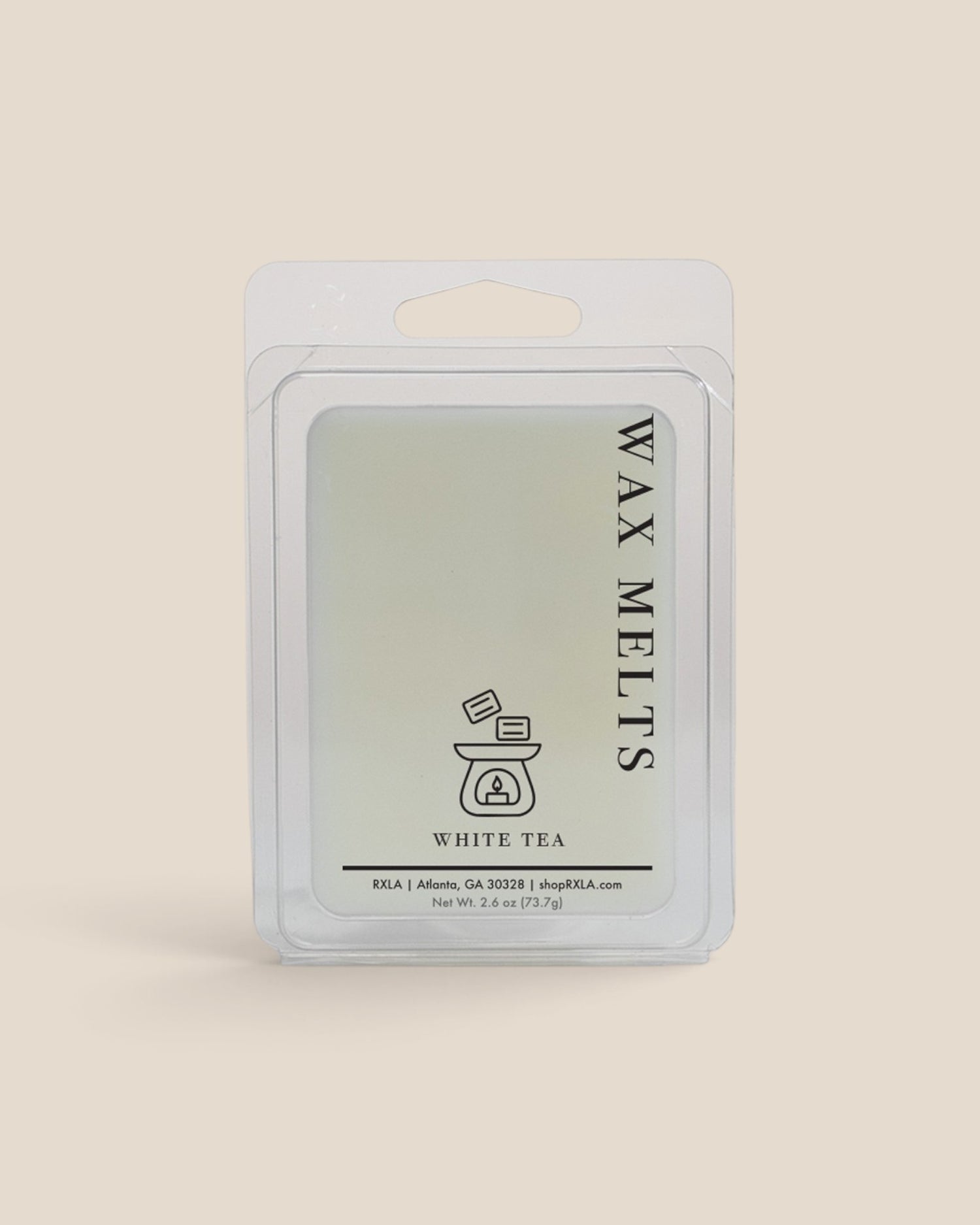 A wax melt package labeled 'WAX MELTS' and 'WHITE TEA' in a clear plastic clamshell pack on a solid light beige background.