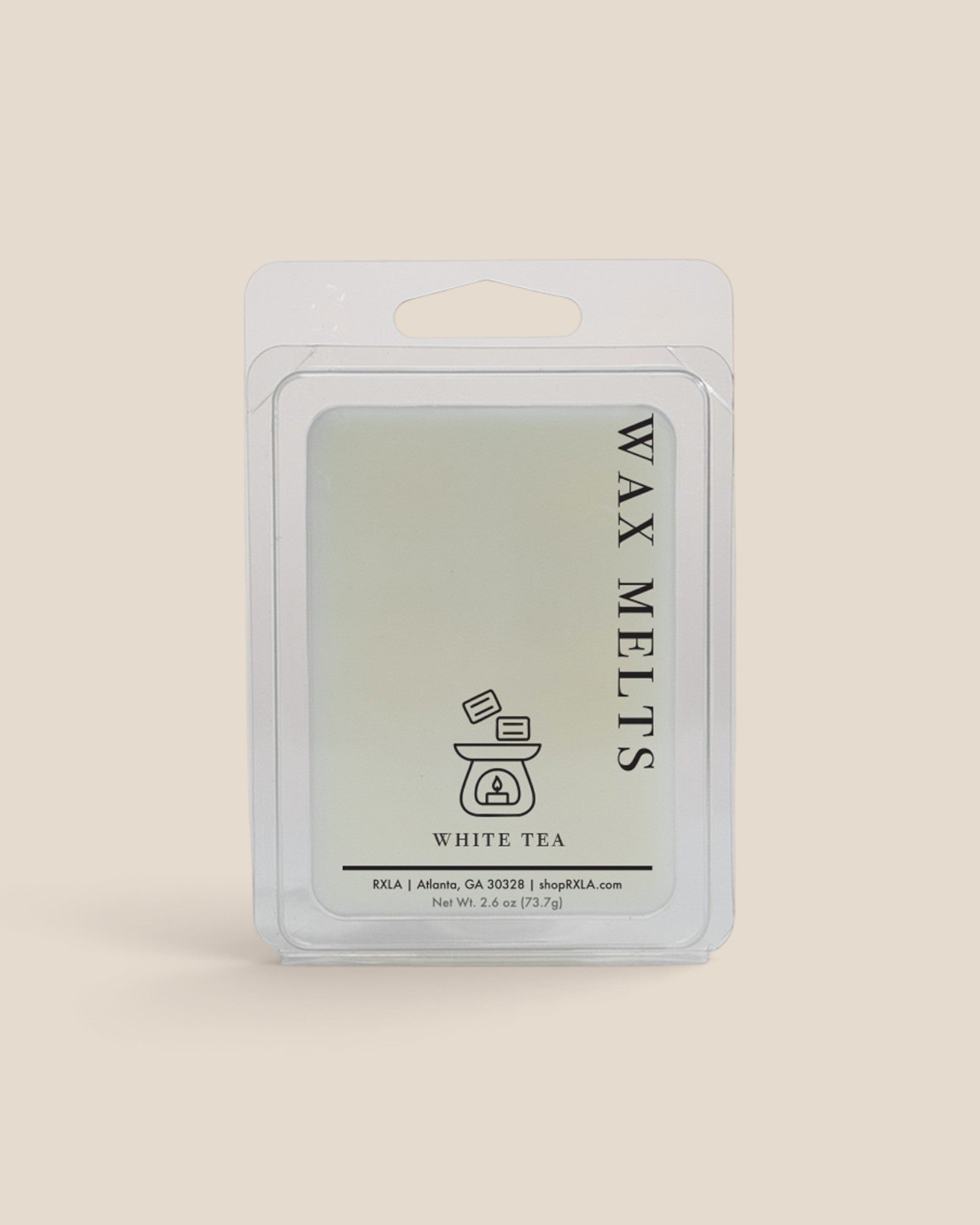 A wax melt package labeled 'WAX MELTS' and 'WHITE TEA' in a clear plastic clamshell pack on a solid light beige background.