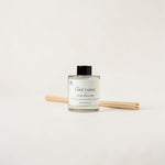 A reed diffuser bottle with a black cap and natural wood reeds, labeled 'LAKE TAHOE' and 'LUXE DIFFUSION', on a clean off-white background.