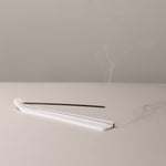 white incense holder and incense