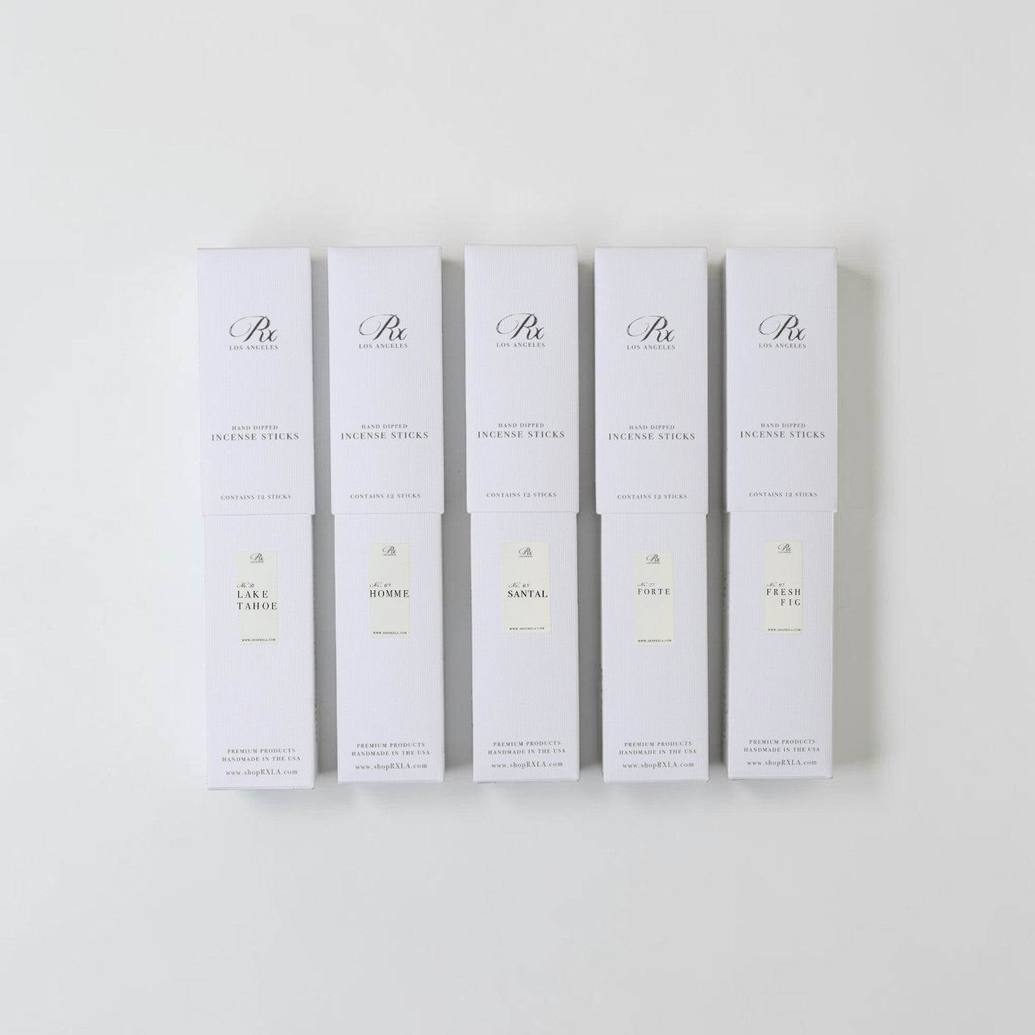 Six white rectangular boxes of Peony Apothecary Incense Sticks arranged in a row against a clean white background. Each box features elegant black script branding and labels for different incense flavors: Cedar Wood, Rose, Oud, Peony, and Iris.