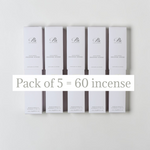 Five white rectangular boxes of incense sticks arranged in two rows on a light gray background, with a white text banner across the center reading 'Pack of 5 = 60 incense'.