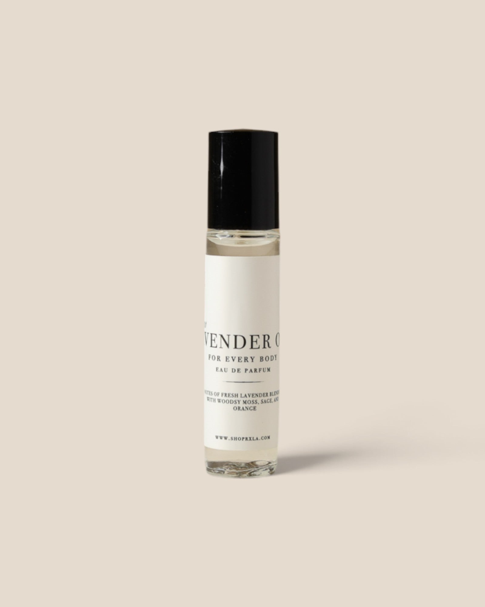 A clear glass rollerball perfume bottle with a white label and black cap, standing upright against a solid light beige background. The label reads 'LAVENDER CO FOR EVERY BODY EAU DE PARFUM'.