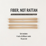 Four sets of natural fiber diffuser reeds displayed horizontally on a clean off-white background, with text above reading 'FIBER, NOT RATTAN' and below stating the set includes 4 sets of diffuser reeds, 10 pieces/set.