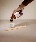 Pouring diffuser refill into container