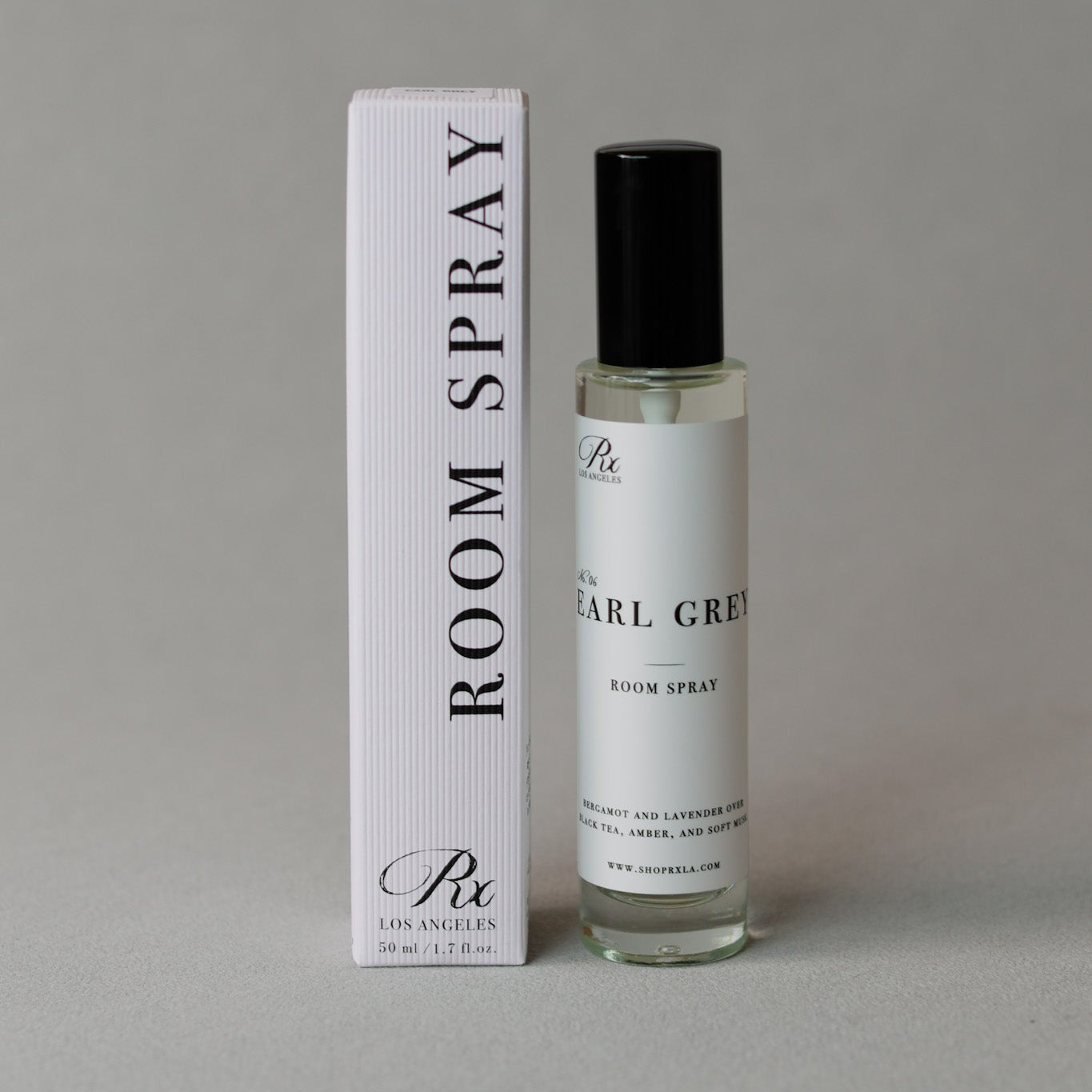 Clear glass room spray bottle labeled Earl Grey—crafted with notes of bergamot, lavender, black tea, amber, and musk for a fresh, calming atmosphere