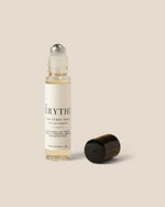 A clear glass rollerball bottle with a white label reading 'EVERYTHING