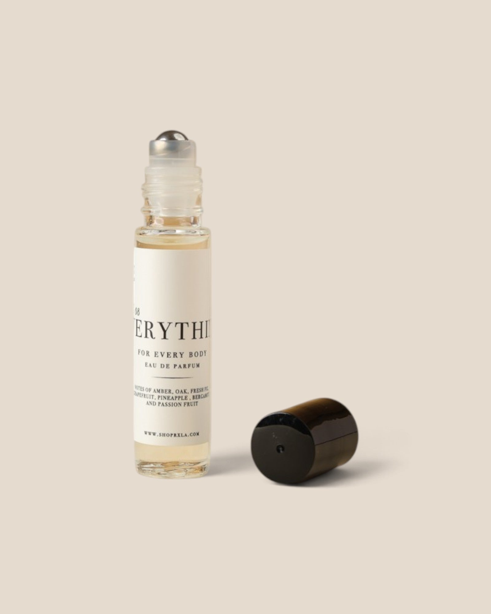A clear glass rollerball bottle with a white label reading 'EVERYTHING